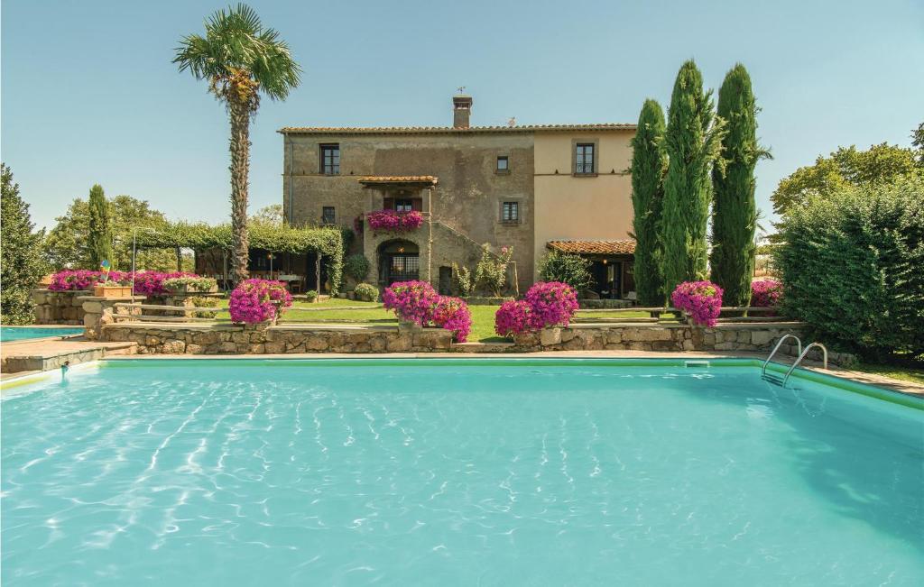 a villa with a swimming pool in front of a house at Villa Arzilla in Vitorchiano