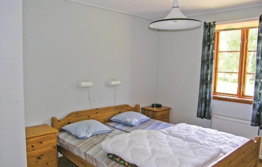a bedroom with a bed and a window at Awesome Home In Broaryd With 2 Bedrooms in Bohult