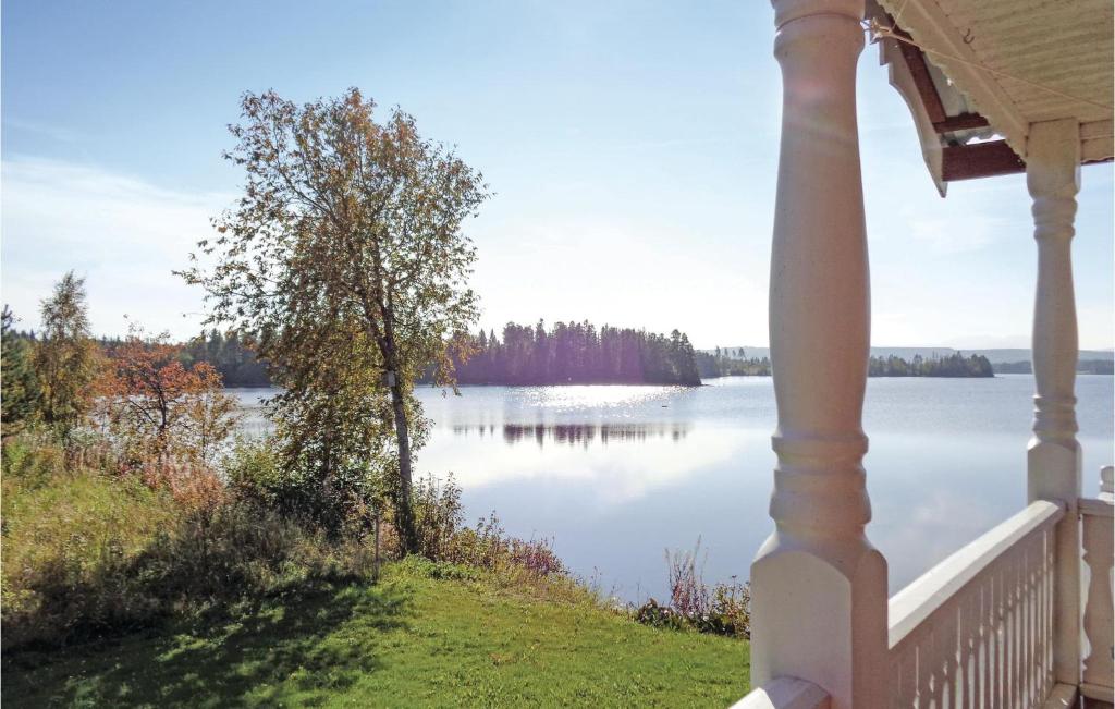 a view of a lake from the porch of a house at Lovely Home In Mattmar With Kitchen in Arvesund