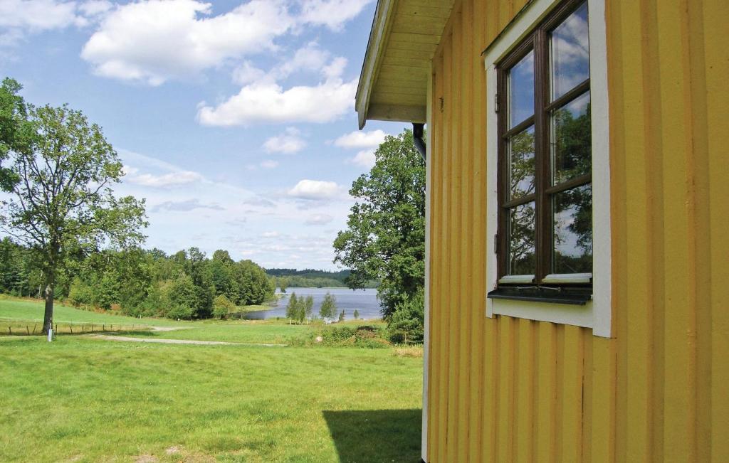 a window of a house with a view of a lake at Awesome Home In Broaryd With 2 Bedrooms in Bohult