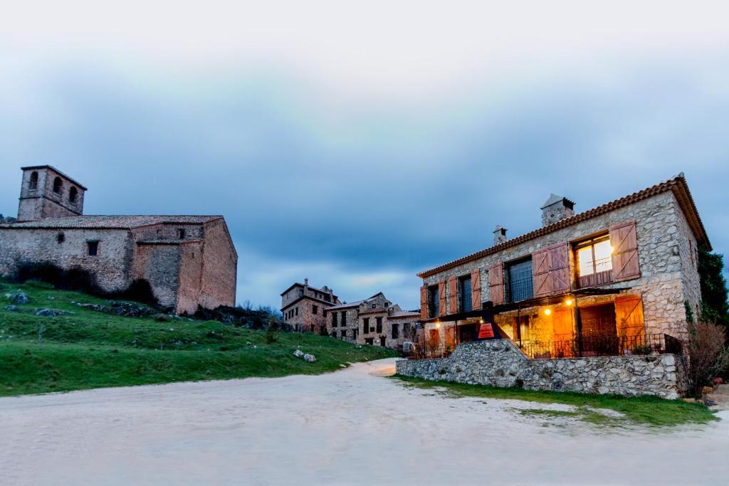 an old stone building on the side of a hill at Casa Rural El Arranca in Riópar