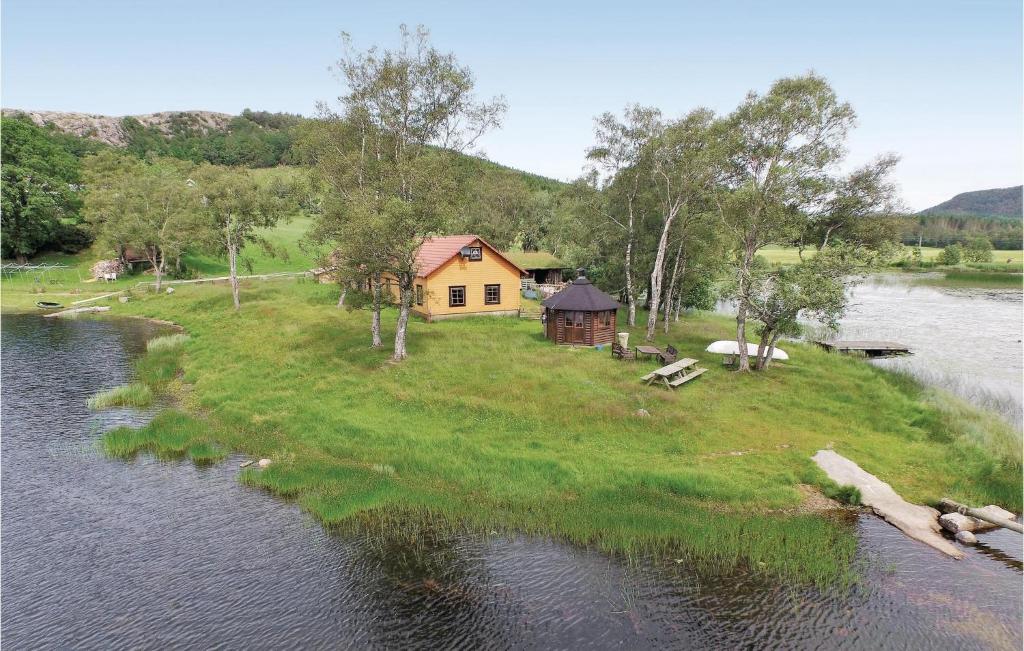 a house on an island in the middle of a river at Cozy Apartment In Sandnes With Kitchen in Bråstein