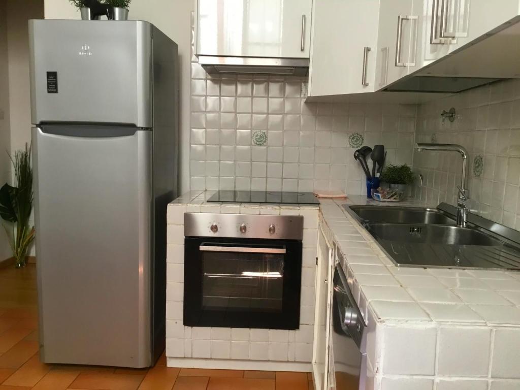 A kitchen or kitchenette at San Firenze Apartment