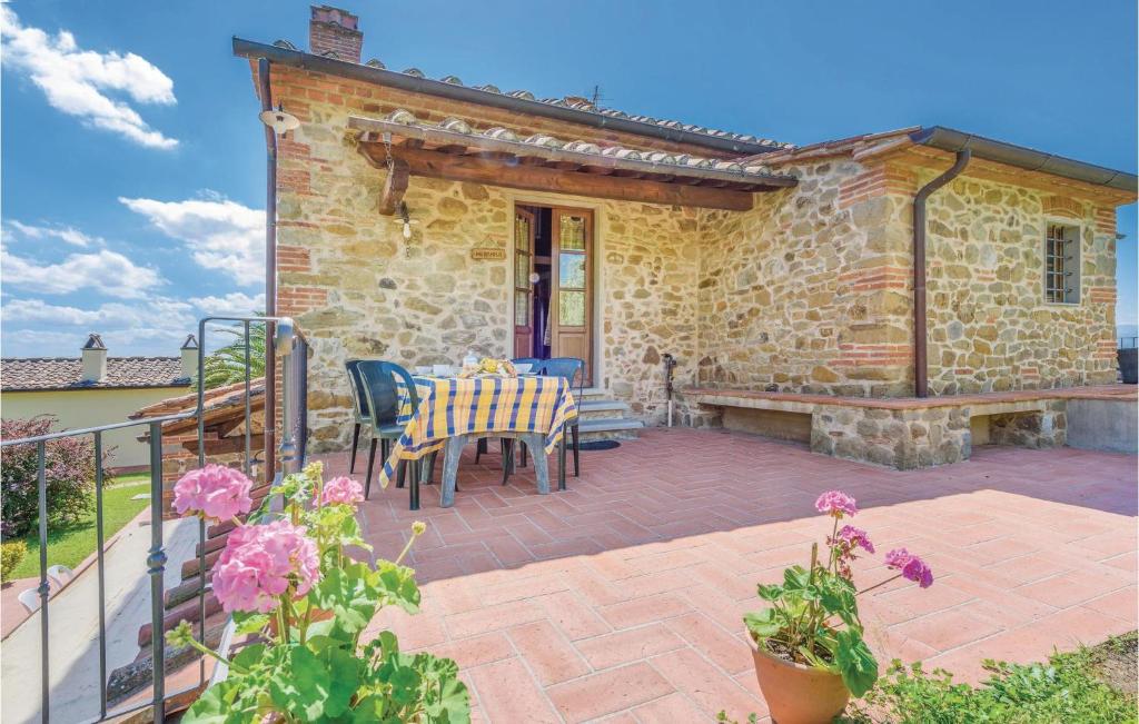 a patio of a house with a table and chairs at Muraiolo in Lamporecchio