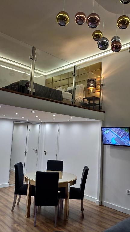 a room with a table and chairs and a bunk bed at Planet Holiday Apartments in Budapest