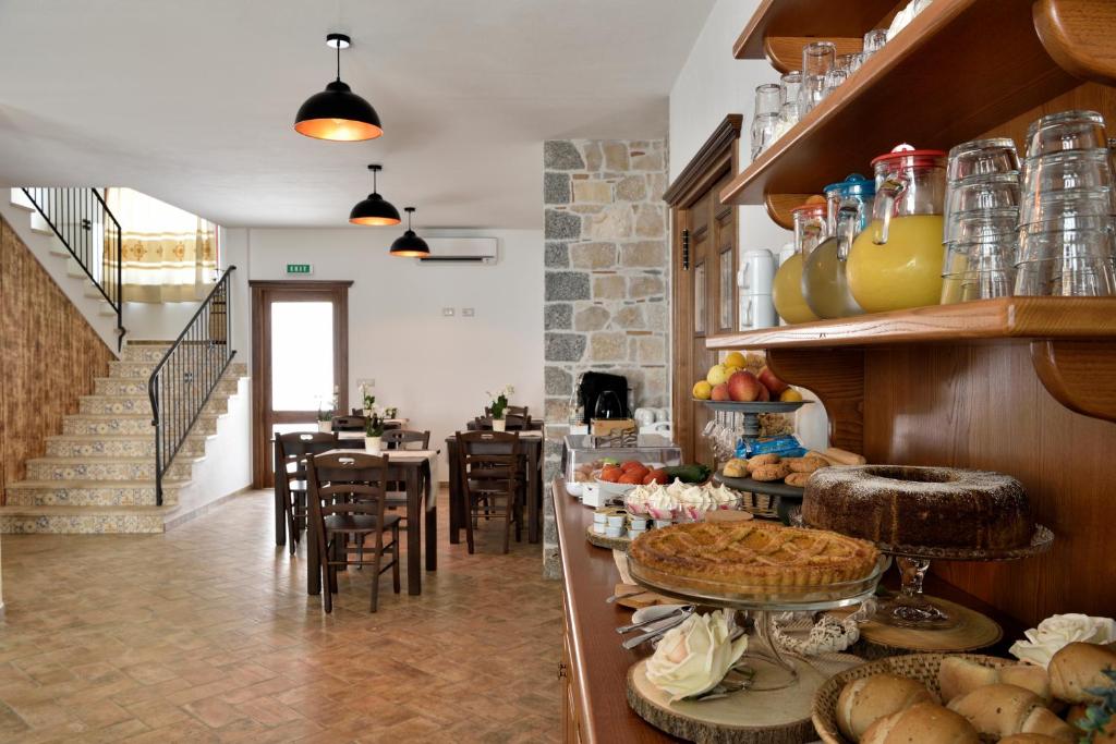 a kitchen with a counter with some food on it at Hotel Goloritzé in Baunei