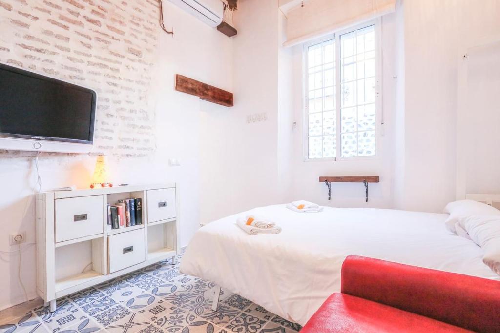A bed or beds in a room at Corazón de Triana. Loft estiloso y confortable.
