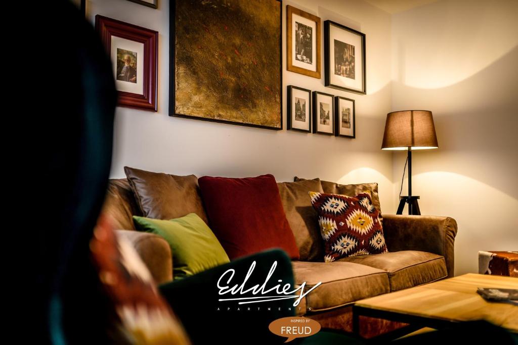 a living room with a couch with pillows on it at Eddie’s Design Apartments in Vienna