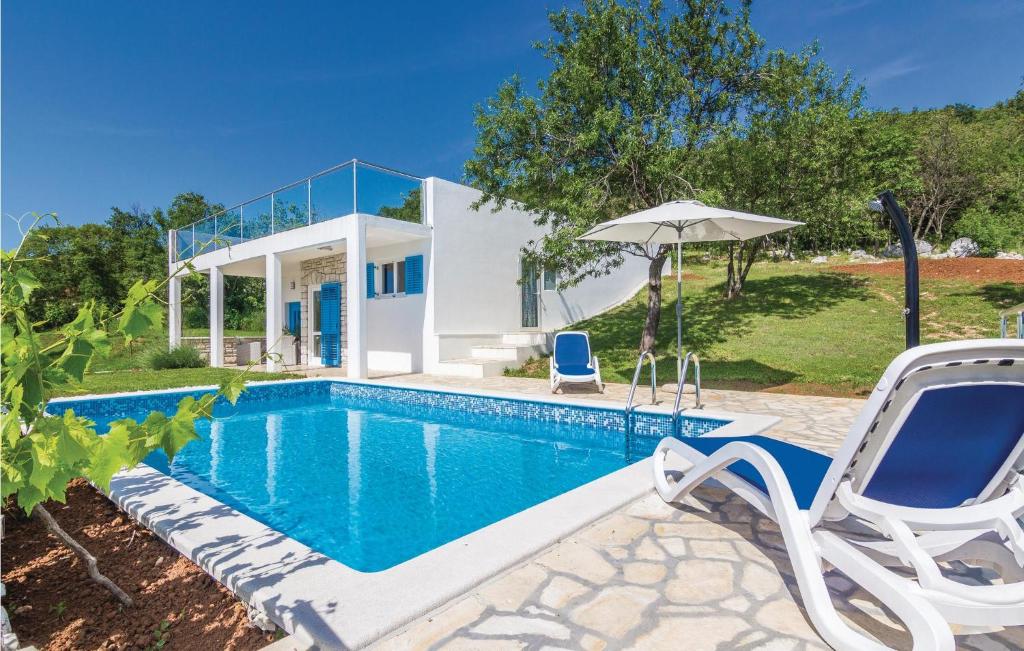 a villa with a swimming pool and a house at Gorgeous Home In Trget With Outdoor Swimming Pool in Trget