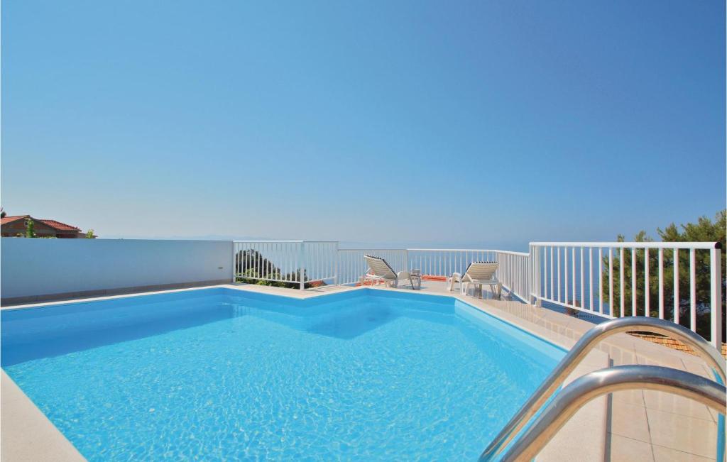 a swimming pool on the balcony of a house at 2 Bedroom Cozy Home In Dingac-potocine in Potomje