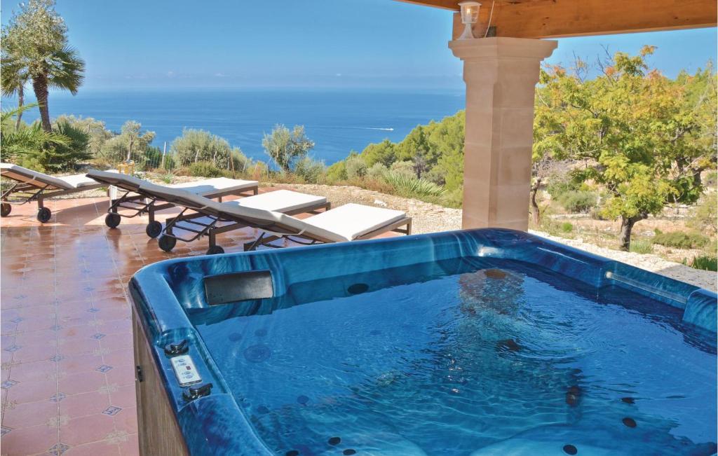 a swimming pool with a view of the ocean at Awesome Home In Estellencs With House Sea View in Estellencs