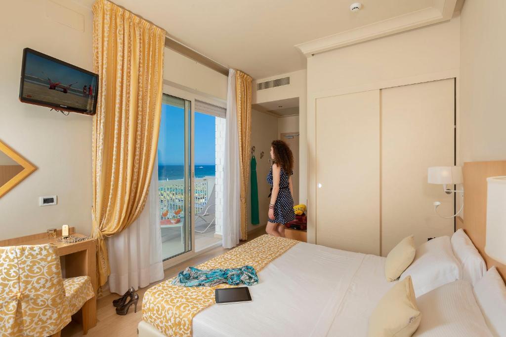 Postel nebo postele na pokoji v ubytování Hotel Ghirlandina