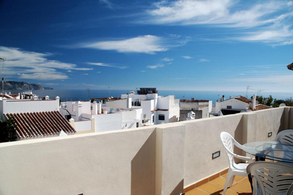 a view from the balcony of a house with a table and chairs at Apartamentos Plaza in Nerja