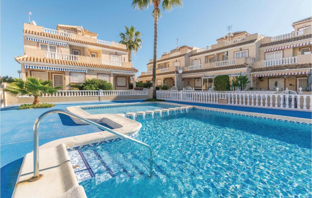 a swimming pool in front of a large building at Residencia Siesta Sol in Torrevieja