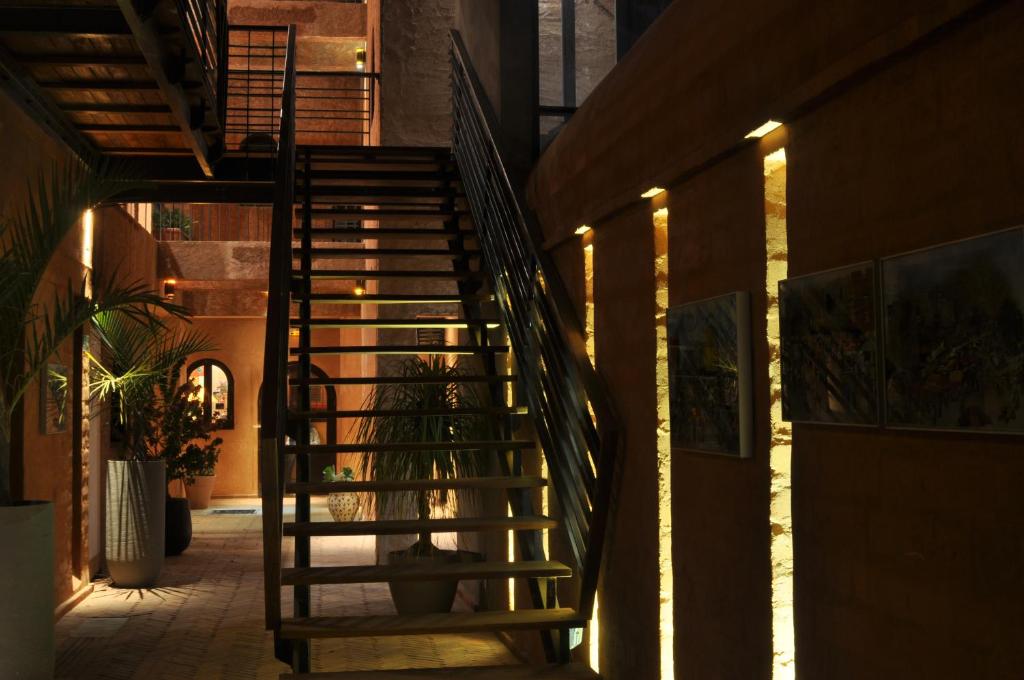 a spiral staircase in a building with a potted plant at Hotel Le Djoloff in Dakar