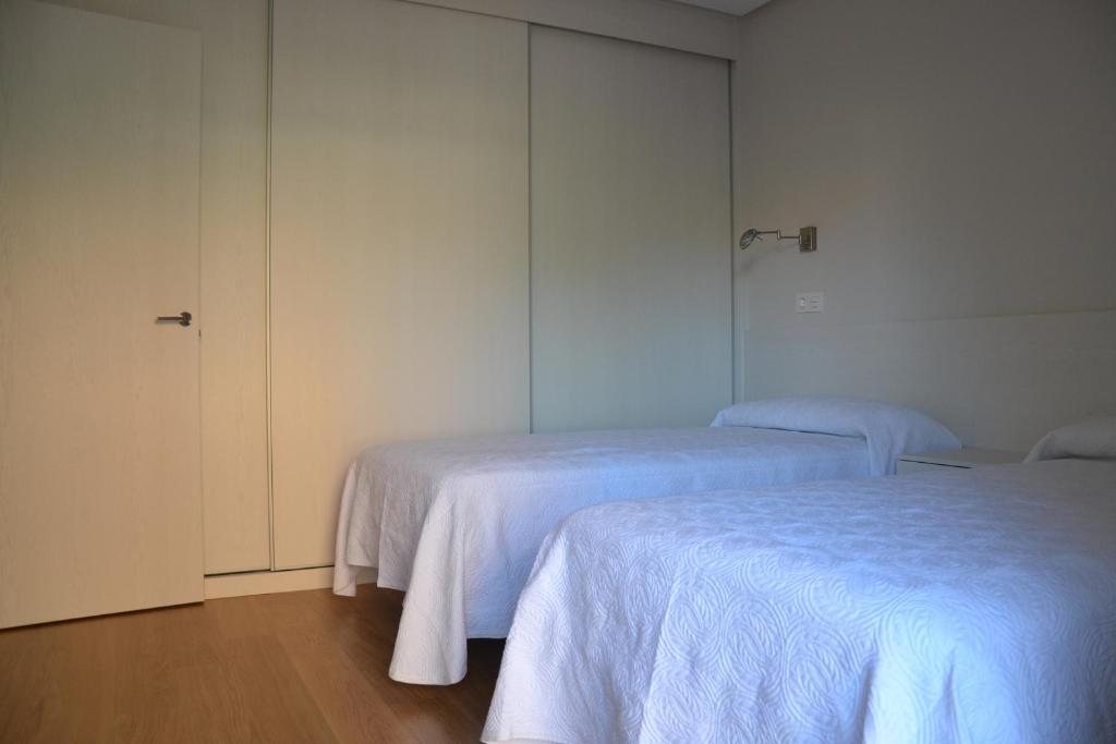 Postel nebo postele na pokoji v ubytování Costa Quebrada Apartamentos