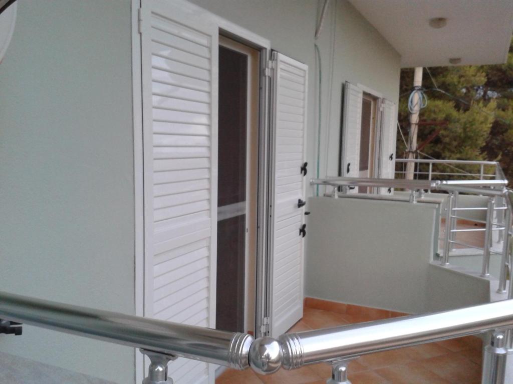 Pokój z drzwiami i balkonem w obiekcie Apartament Gjergji w Sarandzie
