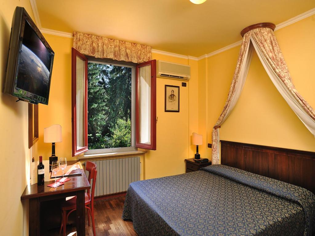 Hotel Bonconte tesisinde bir odada yatak veya yataklar