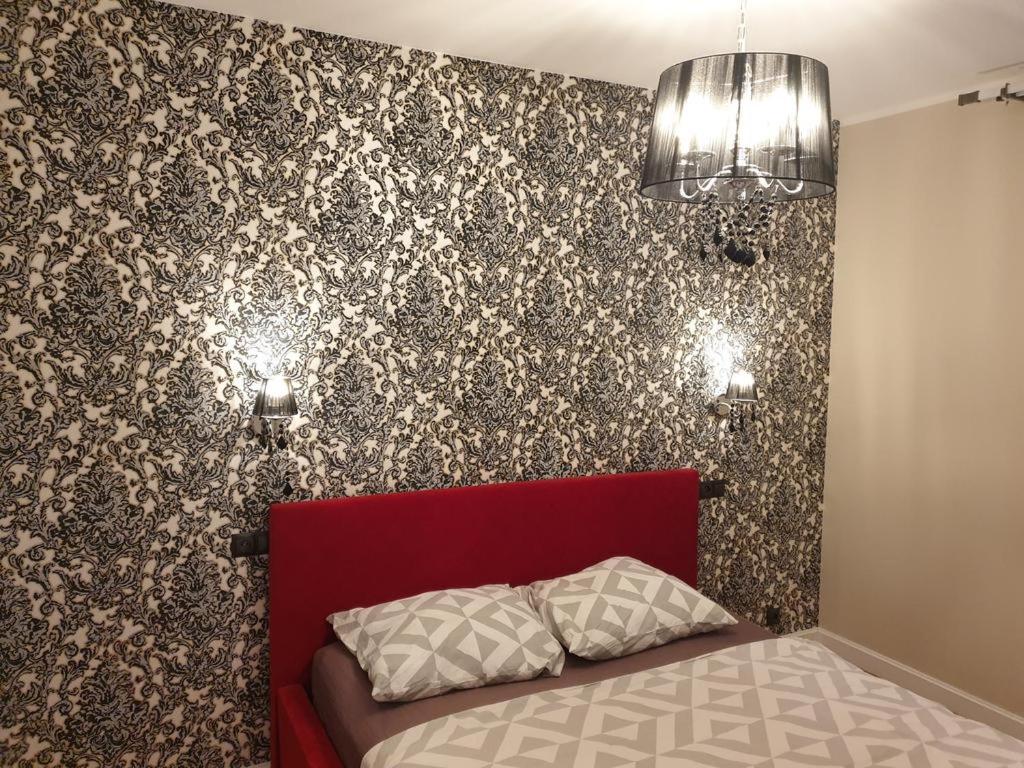 Posteľ alebo postele v izbe v ubytovaní Apartamenty Promenada