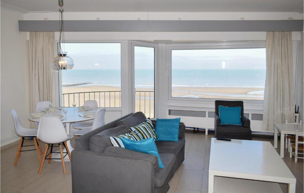 a living room with a couch and a view of the ocean at Residentie Emeraude 4D in Ostend