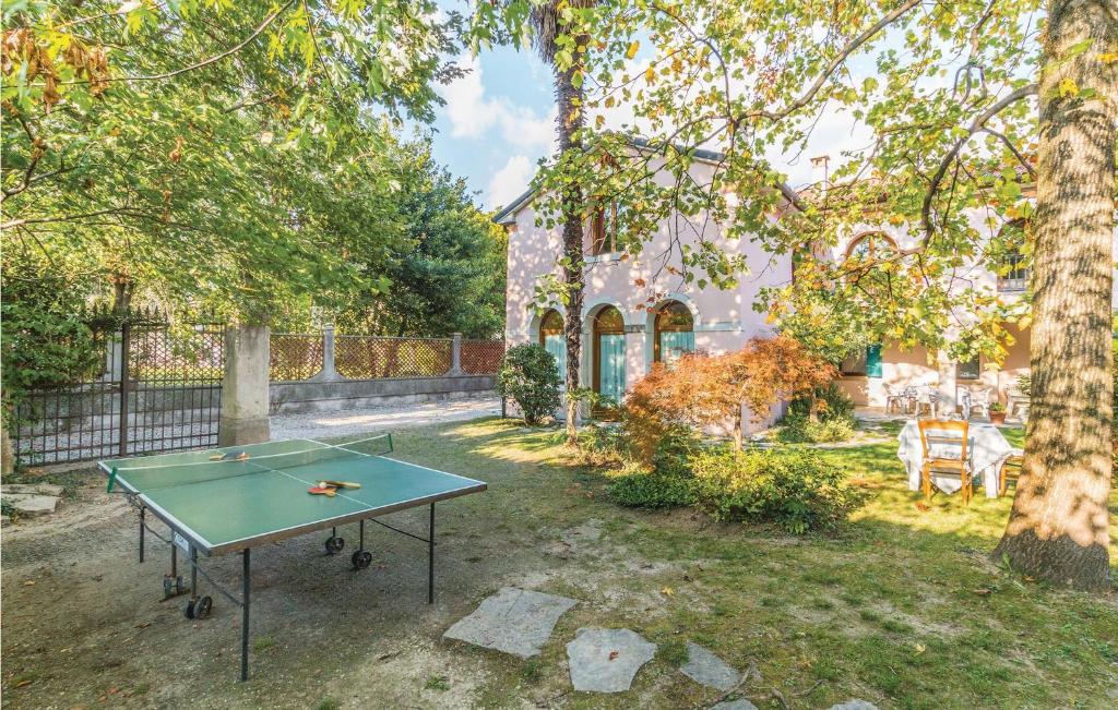 a ping pong table in the yard of a house at Amazing Home In Vittorio Veneto Tv With 3 Bedrooms And Wifi in Vittorio Veneto