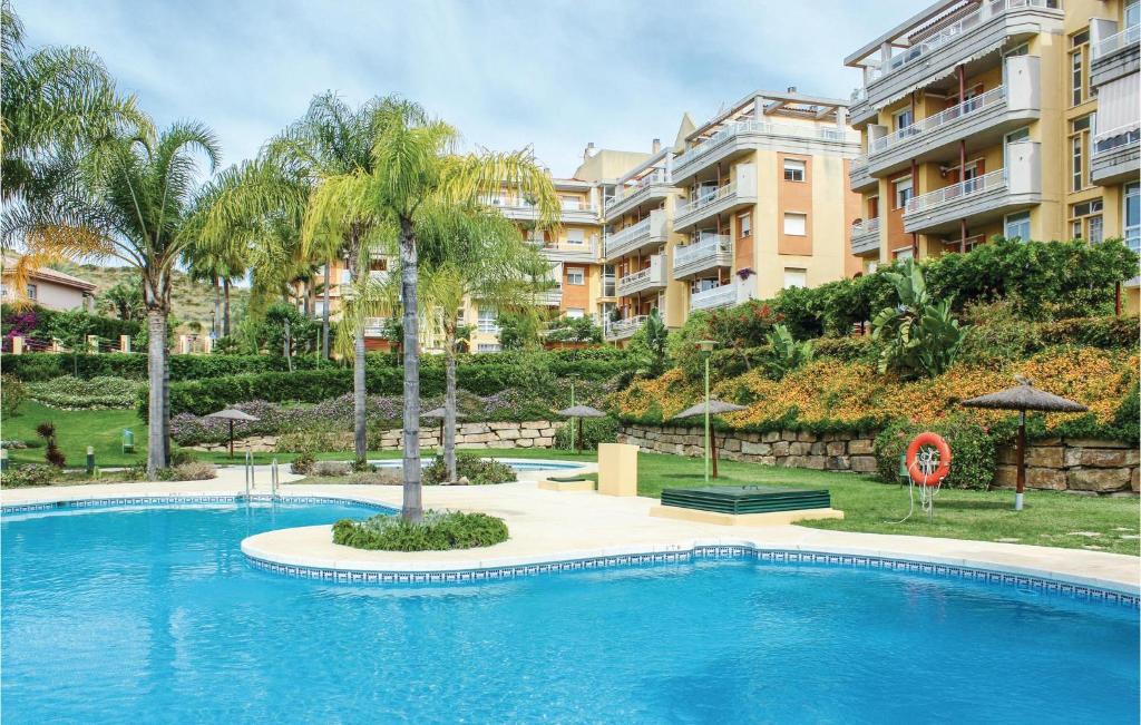 une grande piscine en face d'un bâtiment dans l'établissement Amazing Apartment In Mijas Golf With House A Mountain View, à Mijas