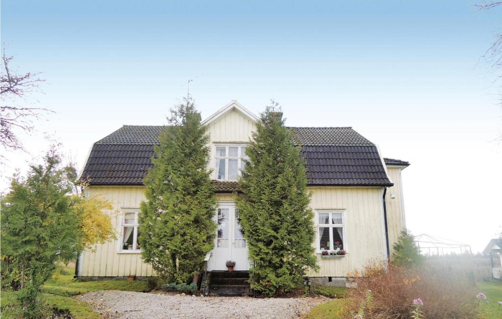 a white house with trees in front of it at Stunning Home In Blidsberg With 2 Bedrooms in Älmestad
