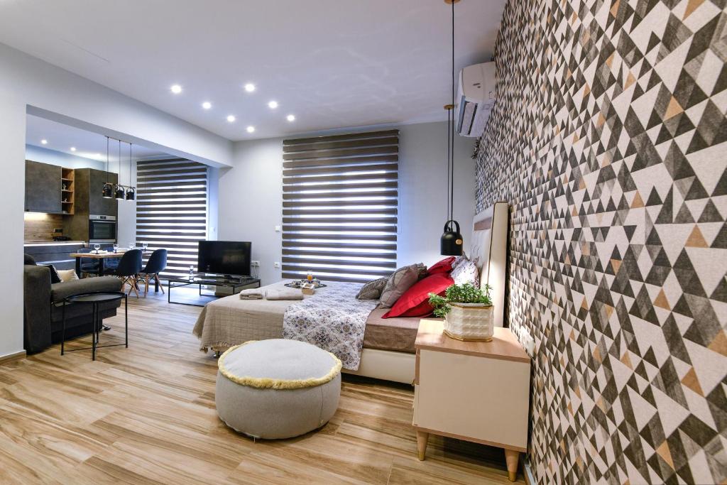 a bedroom with a bed and a living room at Adell Luxury Apartments in Kavála