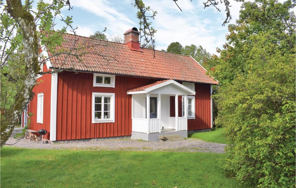 a red and white house with a white window at Amazing Home In Lammhult With Kitchen in Lammhult