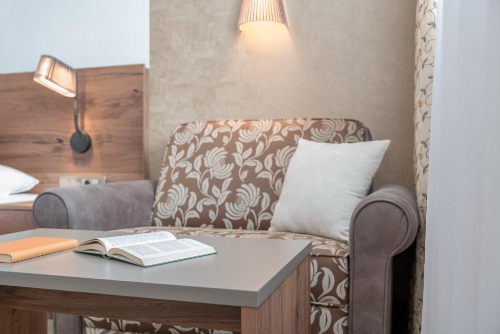 Postel nebo postele na pokoji v ubytování Hotel Madeleine
