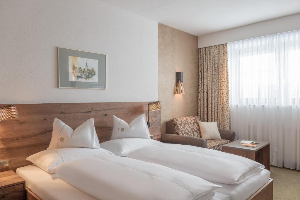 Postel nebo postele na pokoji v ubytování Hotel Madeleine