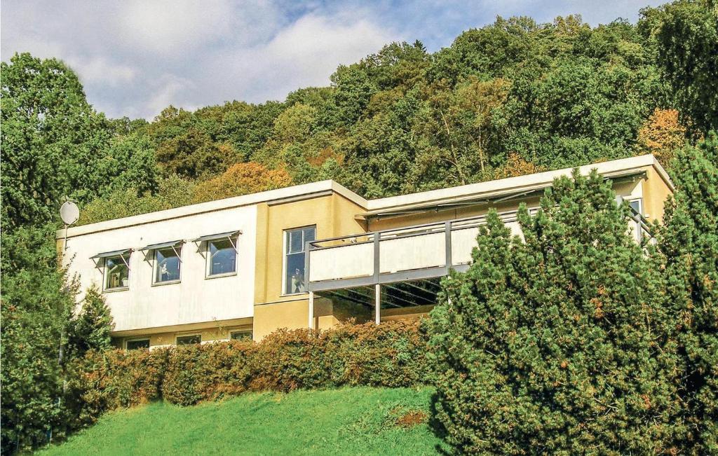 a house on the side of a hill with trees at Stunning Home In Huskvarna With 3 Bedrooms And Wifi in Huskvarna