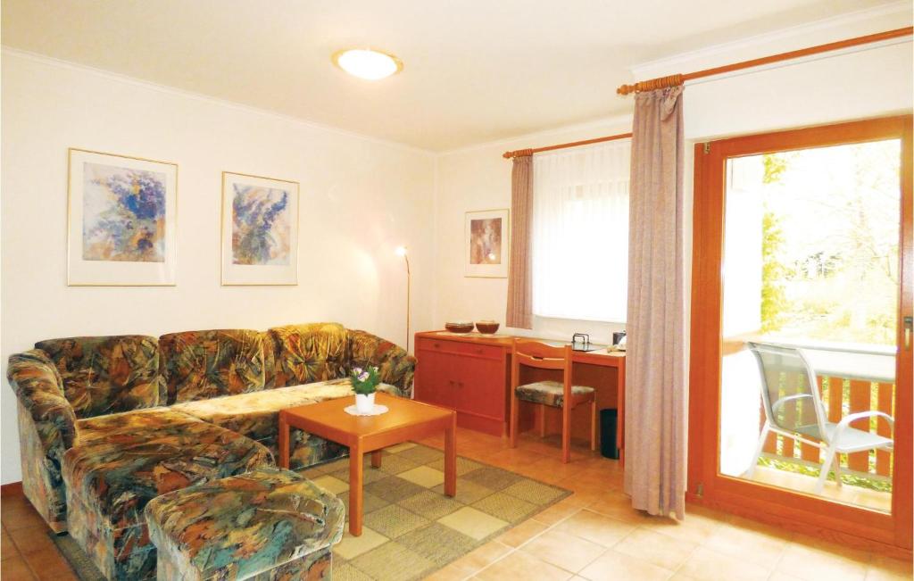 a living room with a couch and a table and a desk at Ferienhaus 22 In Thalfang in Thalfang