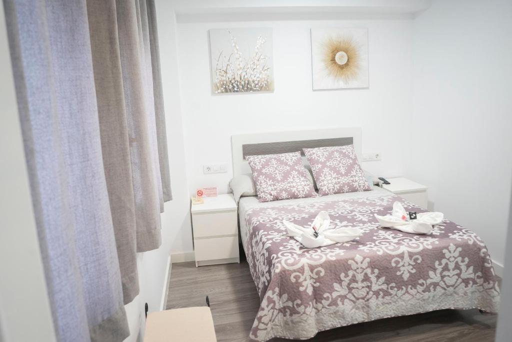 Cama o camas de una habitación en Hostal Goyesco Plaza