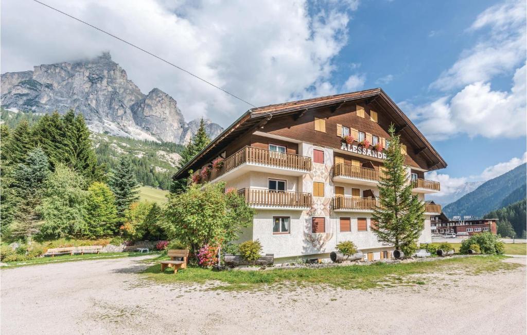 a large building with a mountain in the background at Residence Alessandra in Corvara in Badia