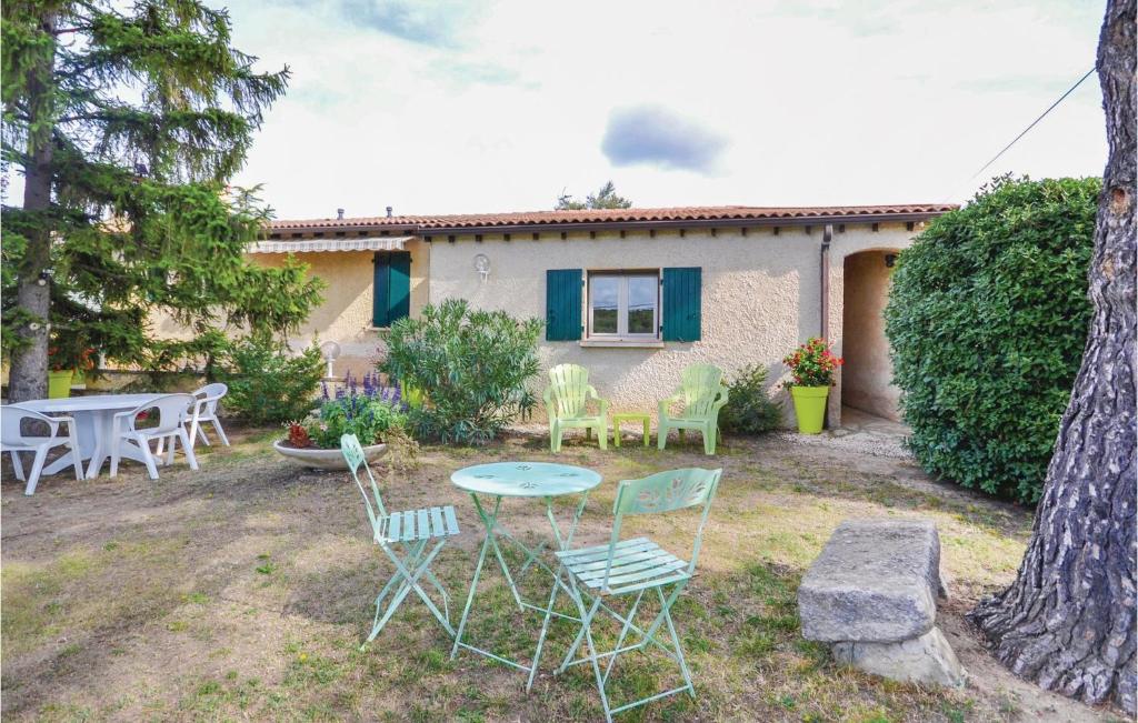 a table and chairs in the yard of a house at 1 Bedroom Awesome Home In Visan in Visan