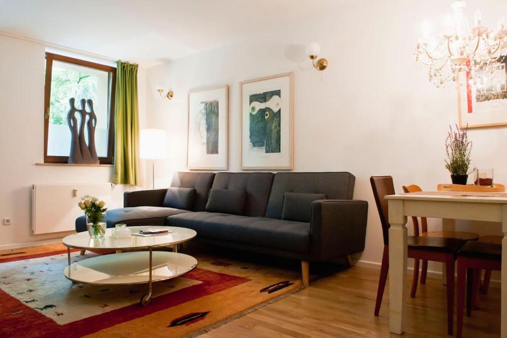 a living room with a couch and a table at Beautiful Park Apartment for 4 Guests in Berlin