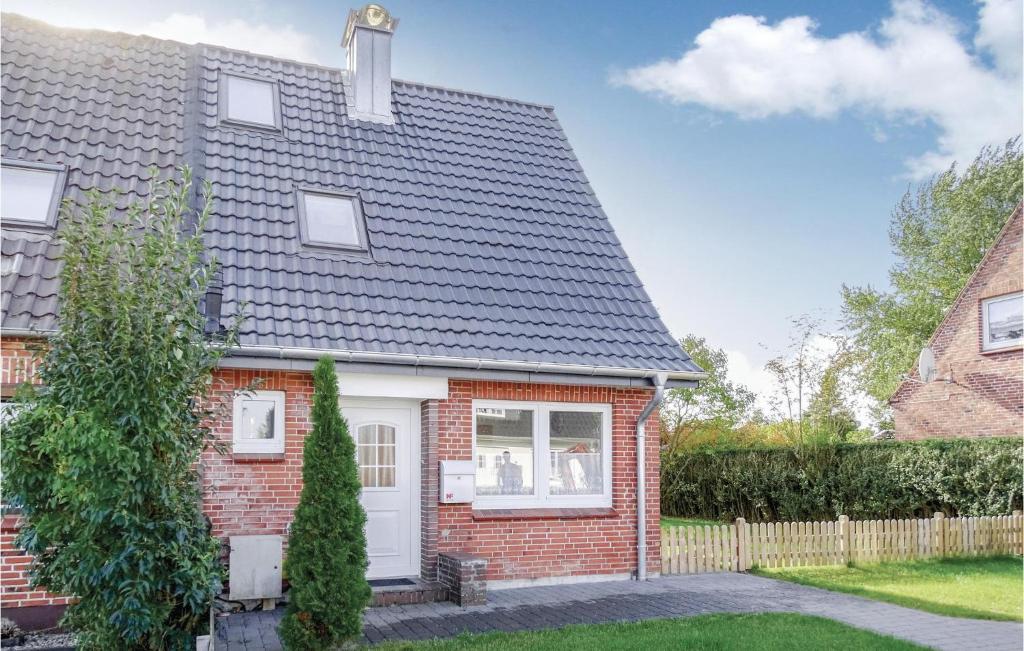 a red brick house with a gray roof at Stunning Home In Gelting With Kitchen in Gelting