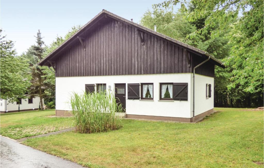 a small white house with a black roof at Ferienhaus 14 In Thalfang in Thalfang