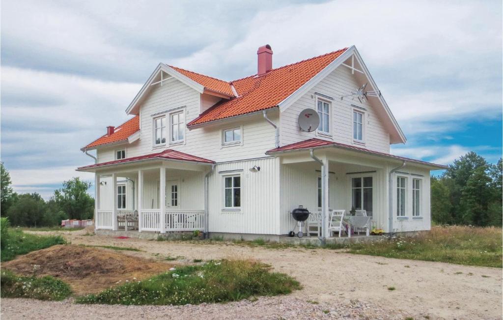 a white house with an orange roof at Beautiful Home In Gnosj With 4 Bedrooms in Gnosjö