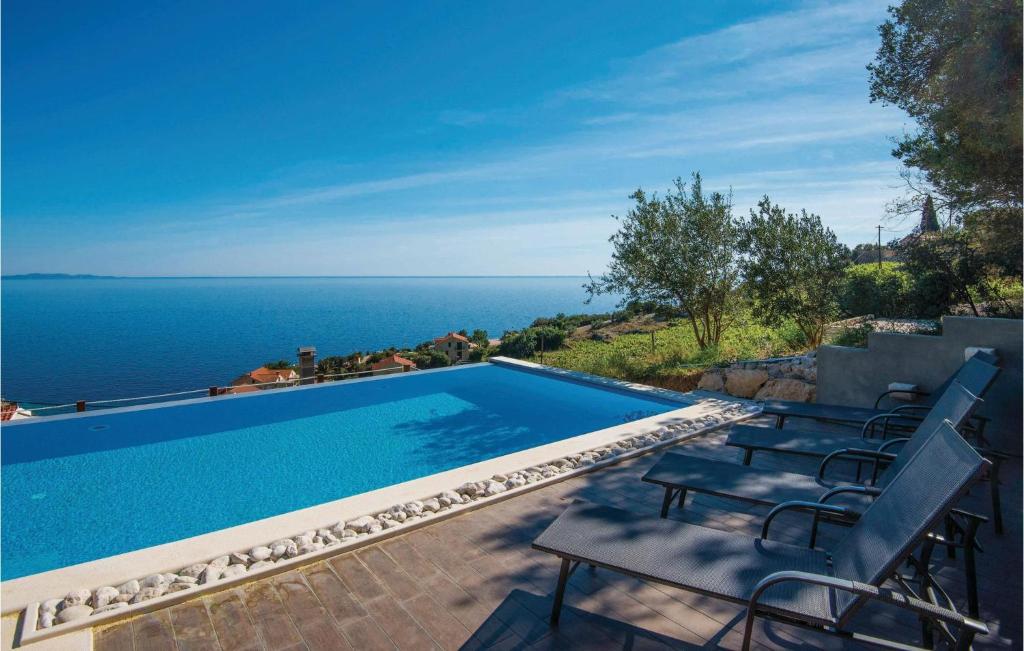 a swimming pool with a view of the ocean at Beautiful Home In Podobuce With Kitchen in Podobuče