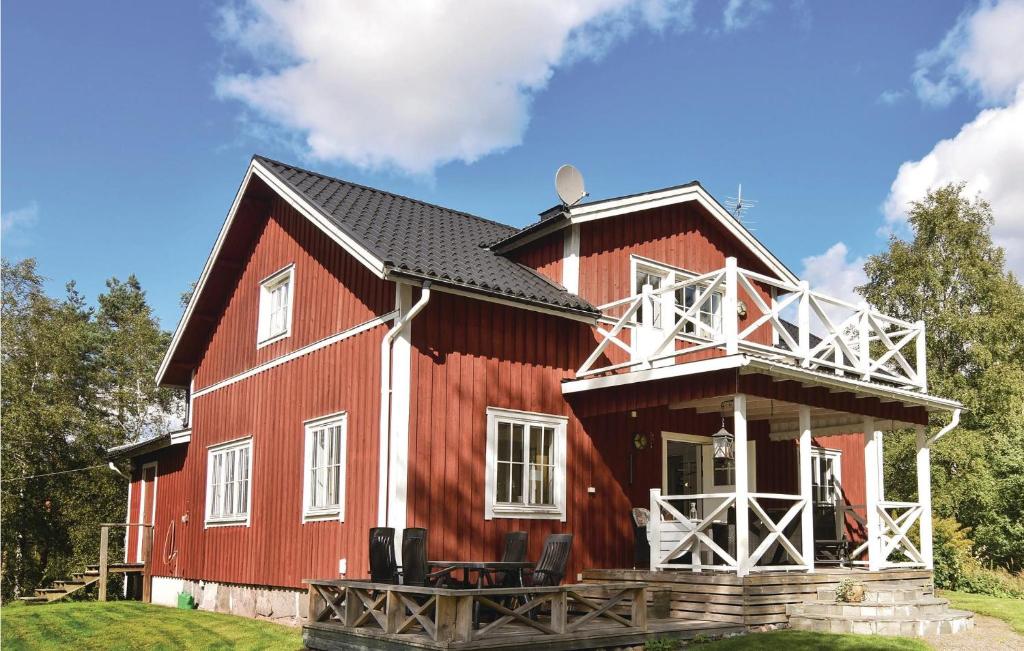 a red barn with a black roof at 4 Bedroom Nice Home In rjng in Årjäng