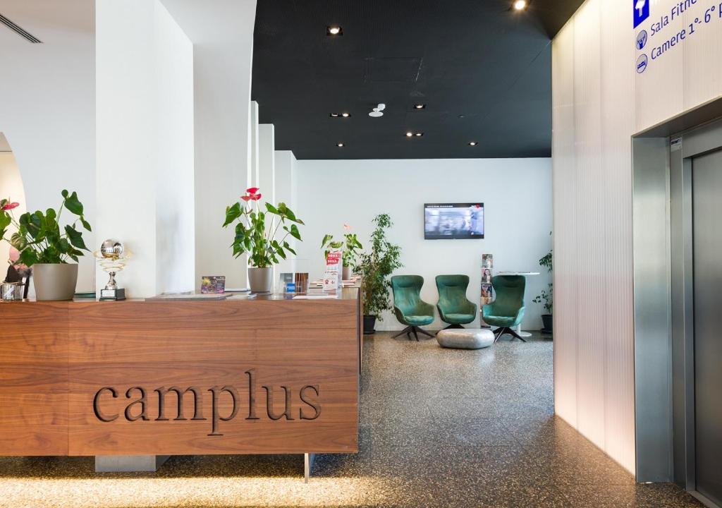 a salon with green chairs and a reception desk at Camplus Roma Casa per Ferie in Rome