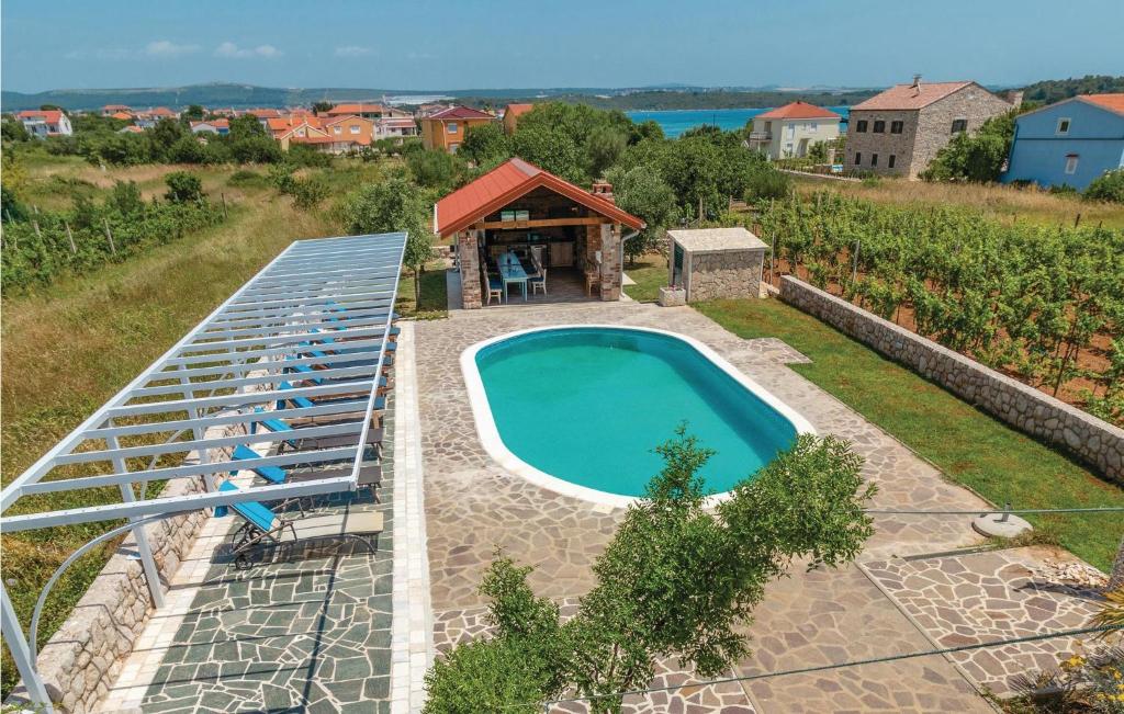 an overhead view of a swimming pool with a gazebo at Awesome Home In Pasman With House Sea View in Pašman