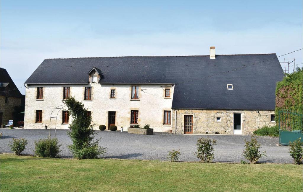 a large white house with a black roof at Nice Home In Canchy With Kitchen in Canchy