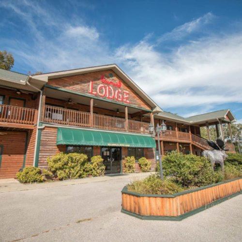 a large building with a sign on the front of it at Bullwinkles Rustic Lodge in Poplar Bluff