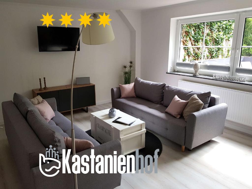 a living room with a couch and stars on the wall at Große, helle Ferienwohnung mit 2 Balkonen auf dem Bauernhof in der Lüneburger Heide in Oetzen