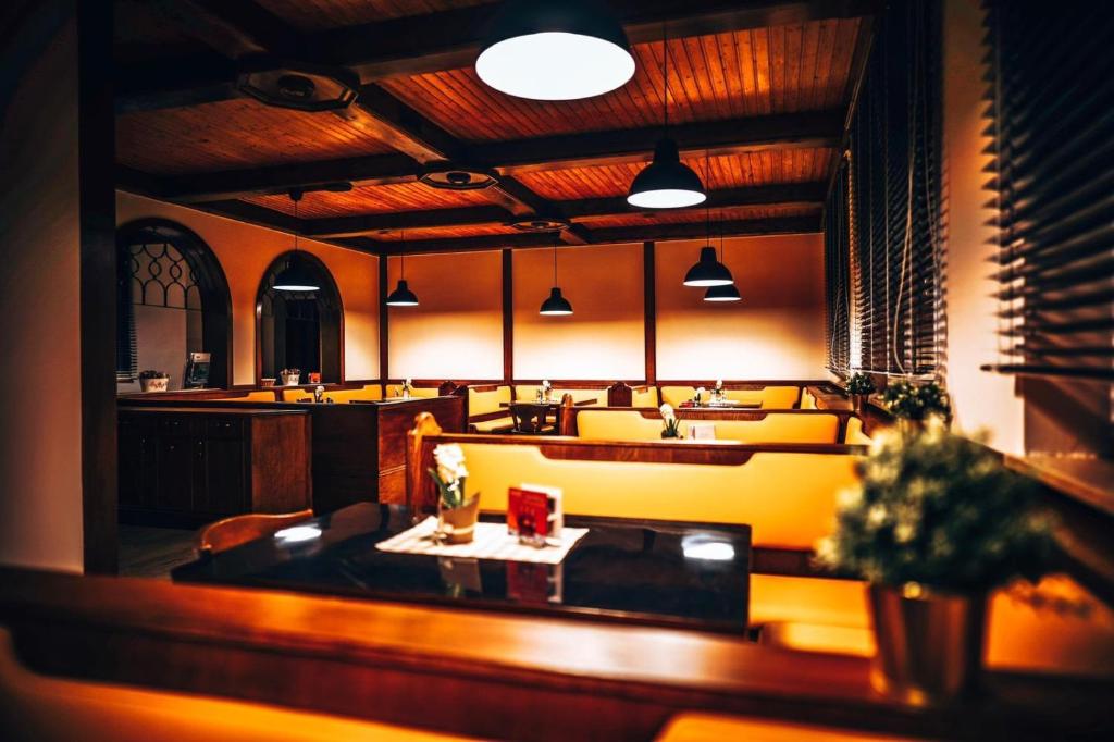 a restaurant with a table and chairs in a room at F Hotel in Hörsching