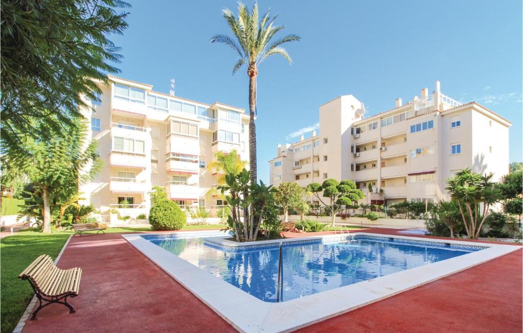 a swimming pool in front of a building at Lovely Apartment In Alfaz Del Pí in L’Alfàs del Pi