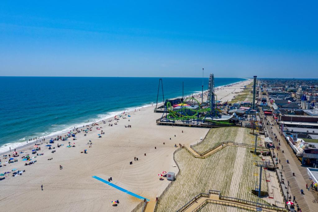 an aerial view of a beach with people on it at Boardwalk Hotel Charlee & Apartments Beach Hotel Oceanfront in Seaside Heights